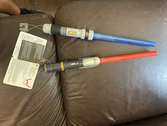 Awesome STARWARS Laser Light Swords.      Red,blue,lights Up.  Brand New,with Tags