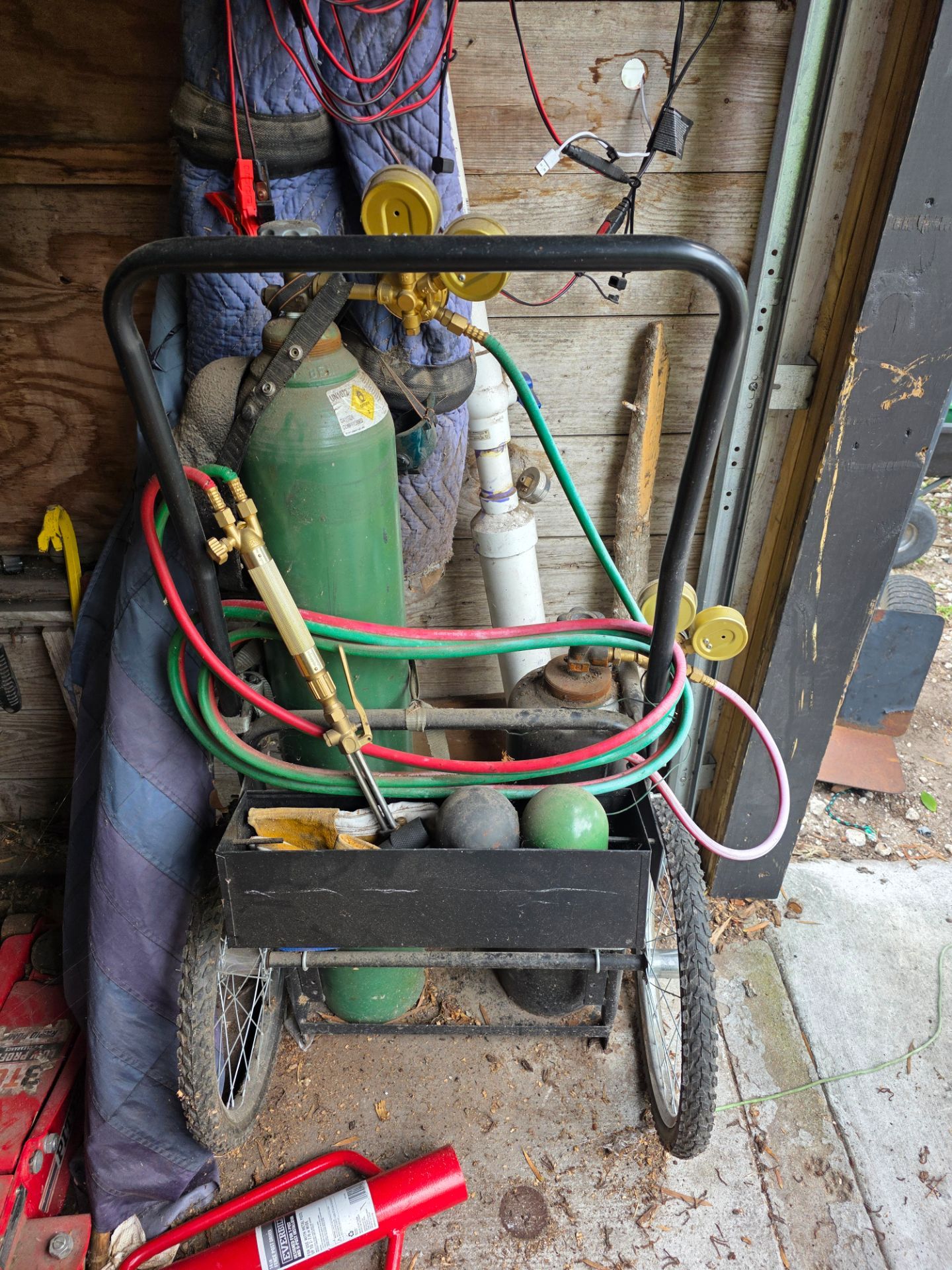 Acetylene and oxygen full bottles with cutting torch , bloom , and brase torch with cart