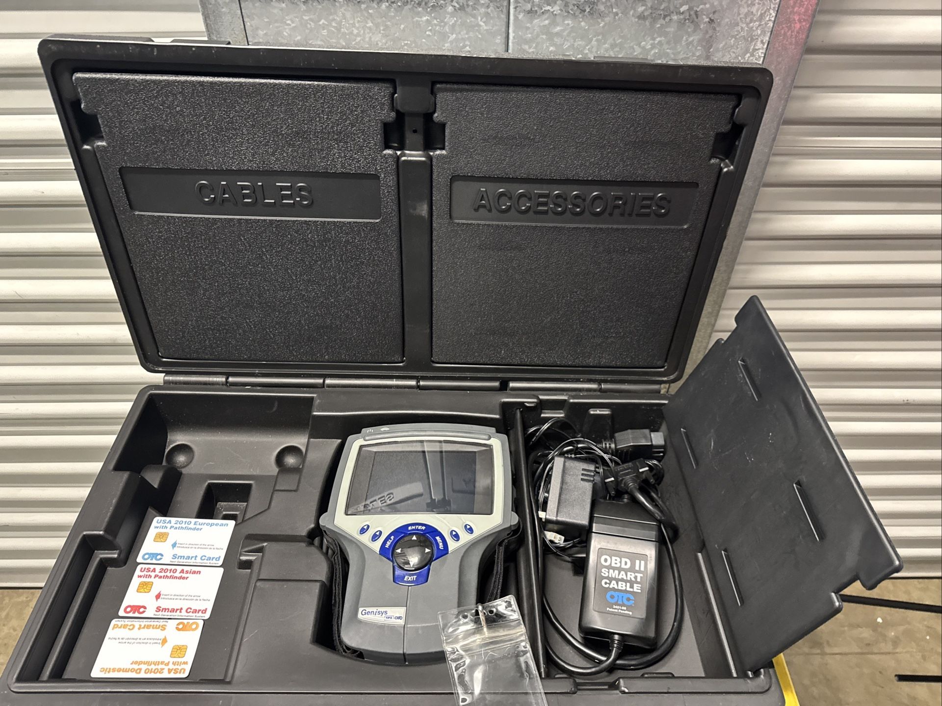 USED GENISYS SPX OTC DIAGNOSTIC SCANNER W/ OBD 2 SMART CABLE AND ACCESSORIES.