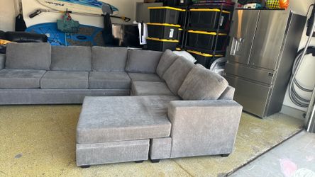 Grey L shaped couch used but good condition