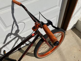 SE Bikes OM Flyer 26 in a Root Beer colorway, featuring a full Chromoly frame with a classic looptail rear end.