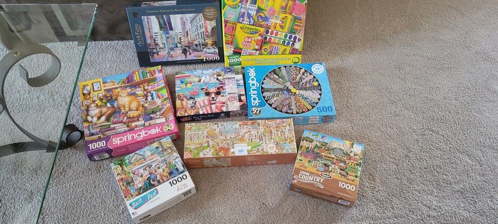 Lots Of 1000 Piece Puzzles And One 500 Piece Puzzle