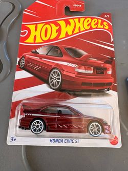 New Hot Wheels Honda Civic Si die-cast car is metallic red with white wheels. This 1:64 scale model is part of a 2022 Honda series and remains in its 