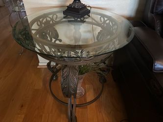Three wrought iron tables with glass tops