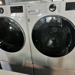 LG 4.5 Cu. Ft. Front Load Washer and 7.4 Cu. Ft. Electric Dryer with TurboWash 360 Laundry Pair in White With Pedestals.