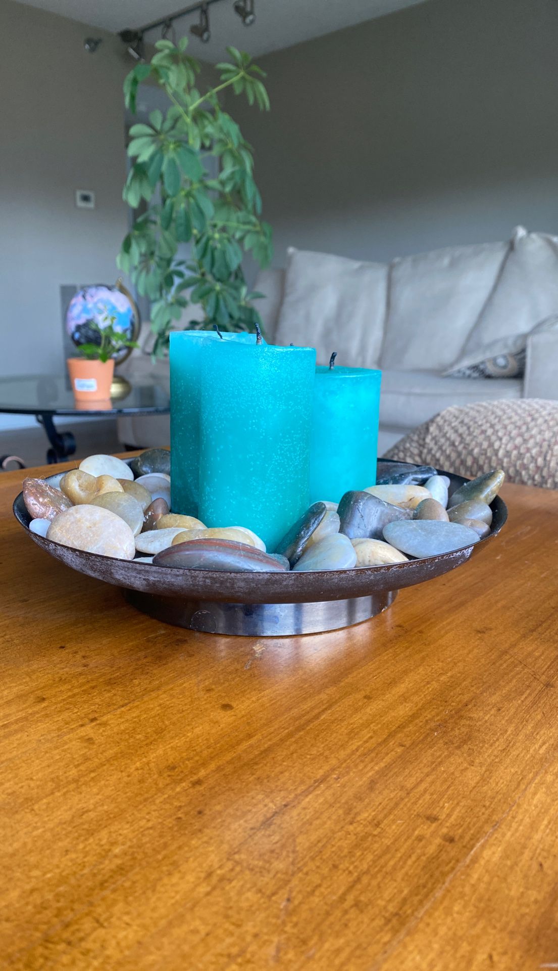 Teal candles in a rock garden