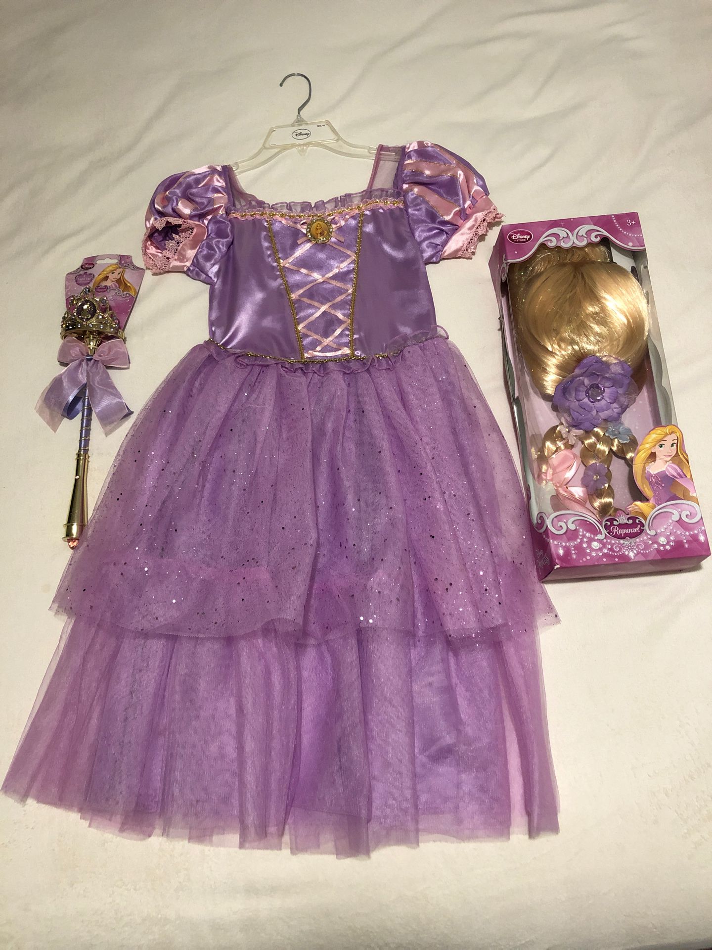 Rapunzel Halloween costume with wig and wand.