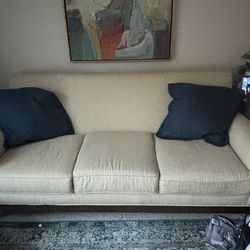 Beige couch with 2 cushions