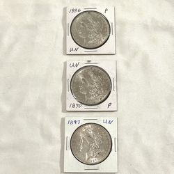 (3)  AU “About Uncirculated) Morgan Silver Coins. Different Years And There Are Collectors Years. Red Description