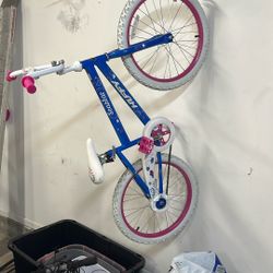 Two Girls Bikes One Has Training Wheels 