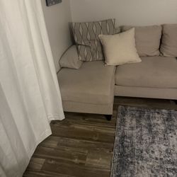 Smaller Beige couch and rug 