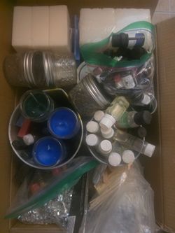 Full box of candle making stuff.