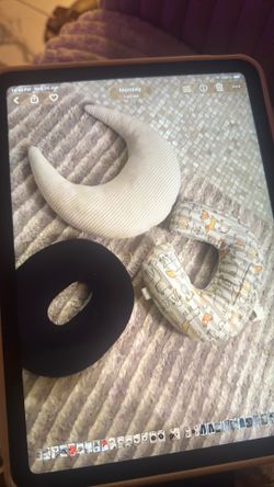 A set of baby pillows: a nursing pillow, a crescent-shaped pillow, and a support pillow.