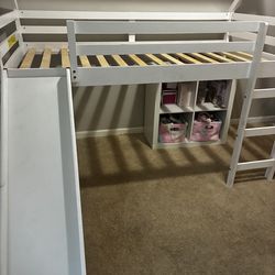 Raised twin bed with slide
