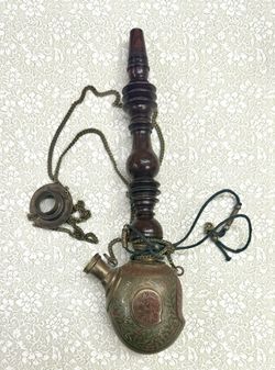 Ancient pipe made of copper and wood