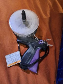 Clothing tagging machine, barbs, and extra needles