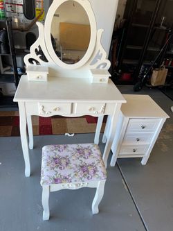 This looks like a vintage-style vanity set with matching stool and side cabinet/nightstand