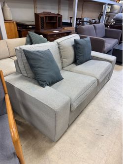 2-seat sofa featured in a neutral light gray fabric