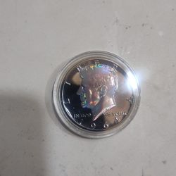 1964 Kennedy 90% Silver Layered In Black Ruthium. Kennedy 's Portrait And Eagle On Reverse Are Hologram Rainbow Colors. 