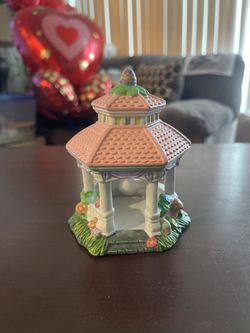 This is a Cottontale Cottages hand-painted porcelain Gazebo village accessory. It is a charming decorative piece typically used for Easter village dis