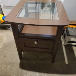 Living room side table W/ glass top Is storage underneath and a drawer