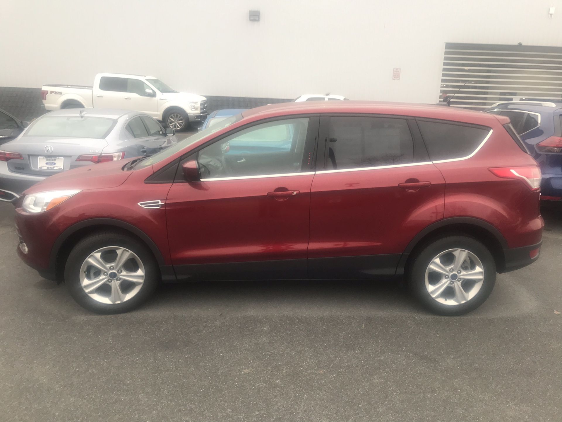 2016 Ford Escape SE FWD in Ruby Red with only 32,183 miles for $13,998.