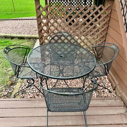 Wrought iron patio set, table and 4 bouncy spring chairs, Delivery Available if needed