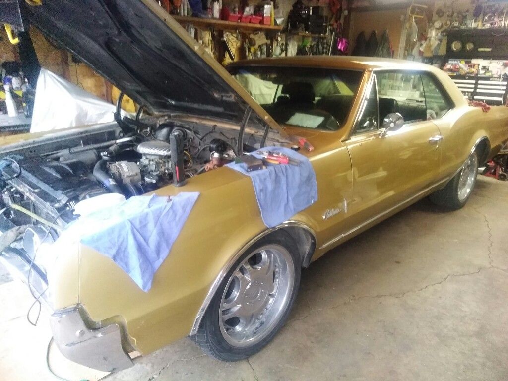 1967 Oldsmobile Cutlass with a motor which I think is a 330 Motors fine runs good has a 400 trans little rust in a couple of places but 99% metal