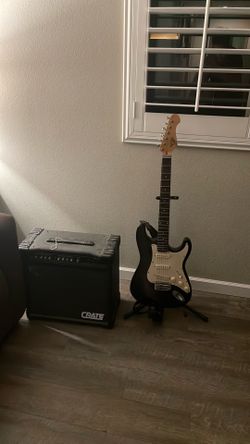 Black electric guitar with AMP and Cord for both