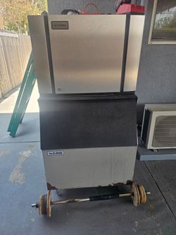 An ice maker and a commercial restaurant sink