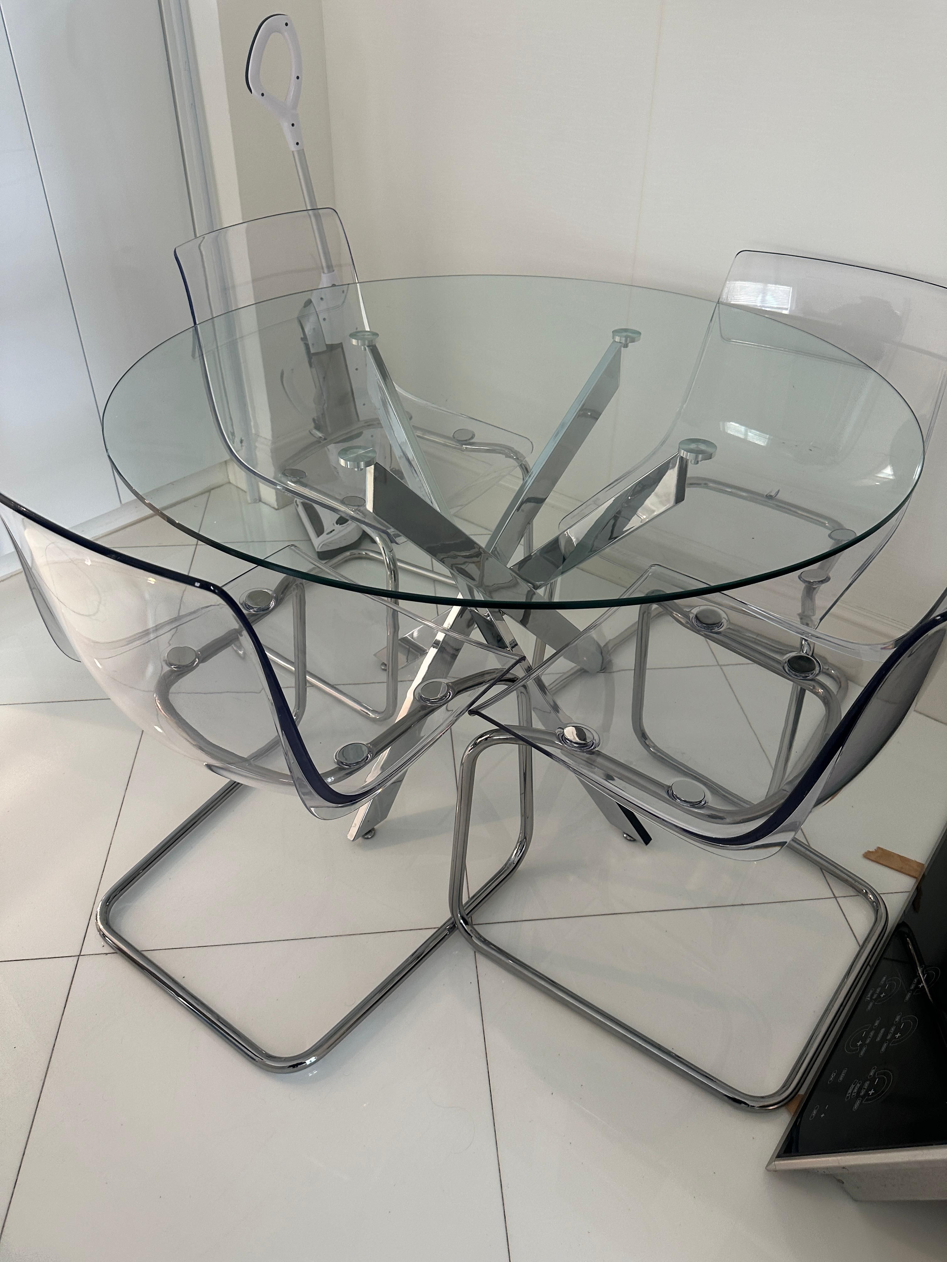 Modern round glass dining table with IKEA Tobias lucite chairs