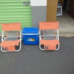 Two Beach Chairs With A Igloo Cooler