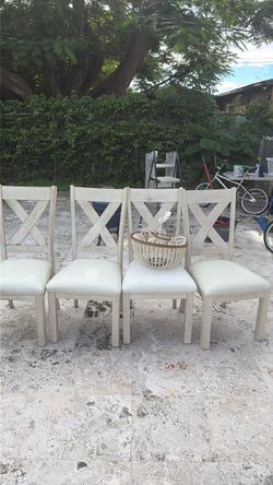 Set of 4 White Wood Dining Chairs comes with a chandelier if you want