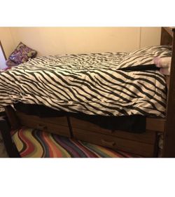 Wooden twin bed with drawers