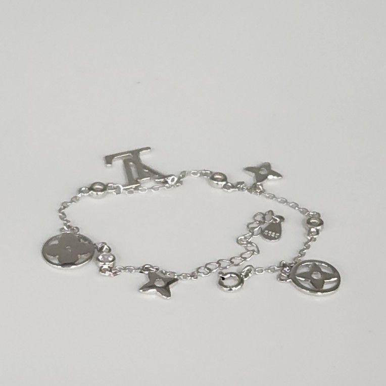 Luxury Style Silver Bracelet With A Flower Cutouts &Crystal Accents  7.5"
