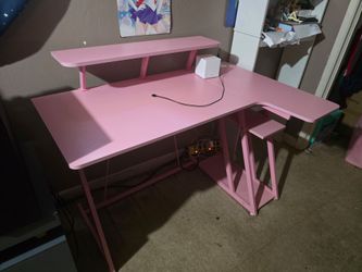 Pink gaming desk with outfits