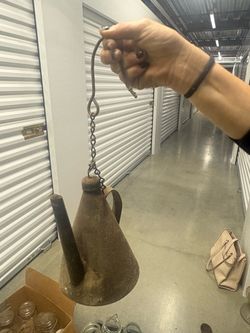 is is a vintage/antique miner's oil lamp (often called a "teapot miner's lamp" or "dumpy lamp").