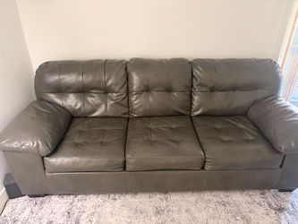 Grey couch can unfold as a bad