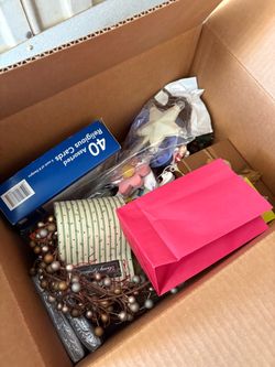 Plastic bins, full of decorations, clothes, and lights for sale