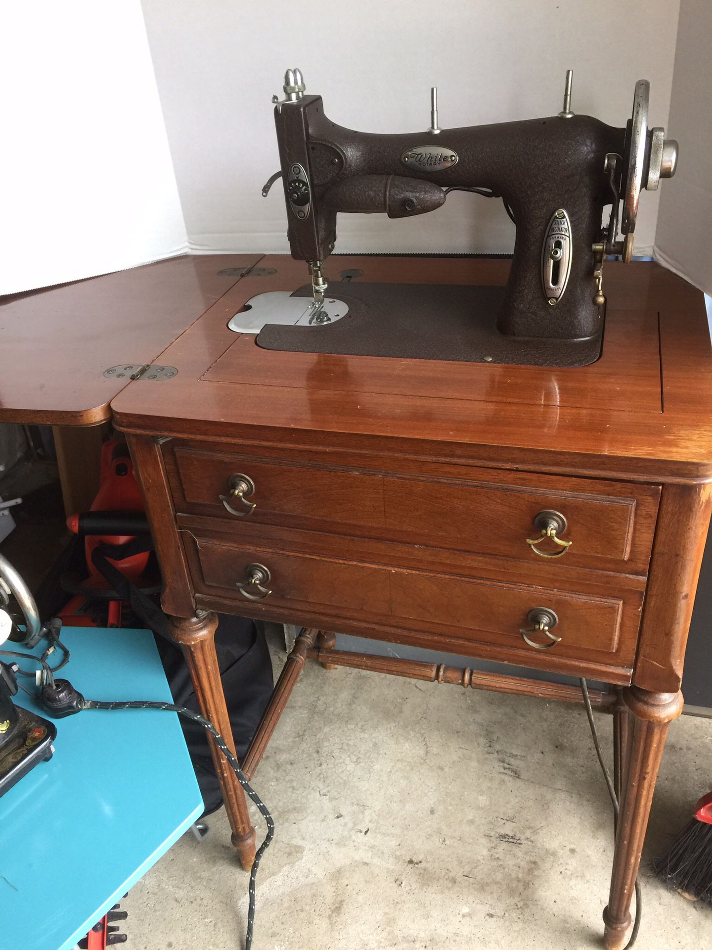 Antique sewing machine in wood cabinet