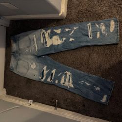 Heavily Distressed Light Wash Denim Jeans