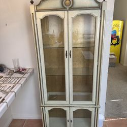 French Provincial style china cabinet or curio cabinet with a distressed white and gold finish