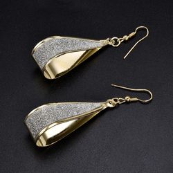 Dangle gold tone earrings