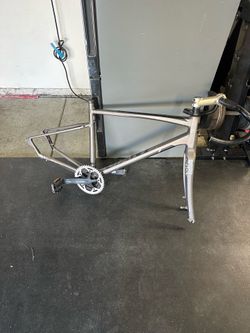 Aluminum Giant Revolt gravel bike frame in a matte silver and black finish. This frame includes the fork, Giant XR drop handlebars, stem, crankset, an