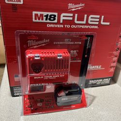 Milwaukee, vacuum and five amp battery with charger