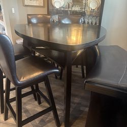 Dining room table with four chairs and bench