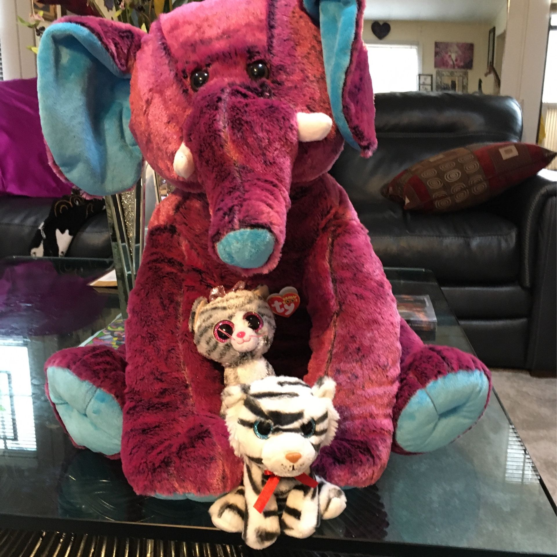 One elephant and two cats stuffed animals