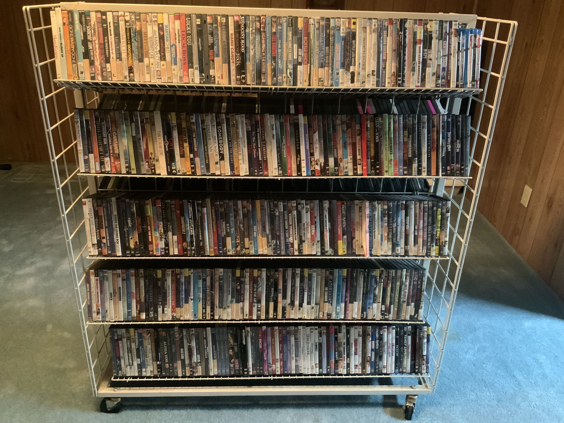 Rolling DVD/bluray/cd/book Rack Will Hold Around 1000 DVDs. 827 Dvds, 16 CDs, 2 PS3, 3 PlayStation 2, 2 Xbox 360 And 6 Blu-ray’s Included. $90 For All