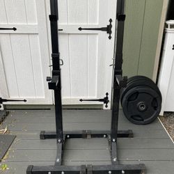 Pair Of Squat Stands And A Black 6’ Olympic Barbell 