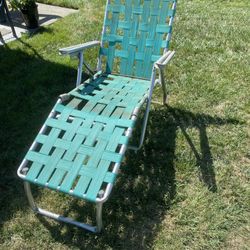 VINTAGE WEBBED CHAISE LOUNGE CHAIR.